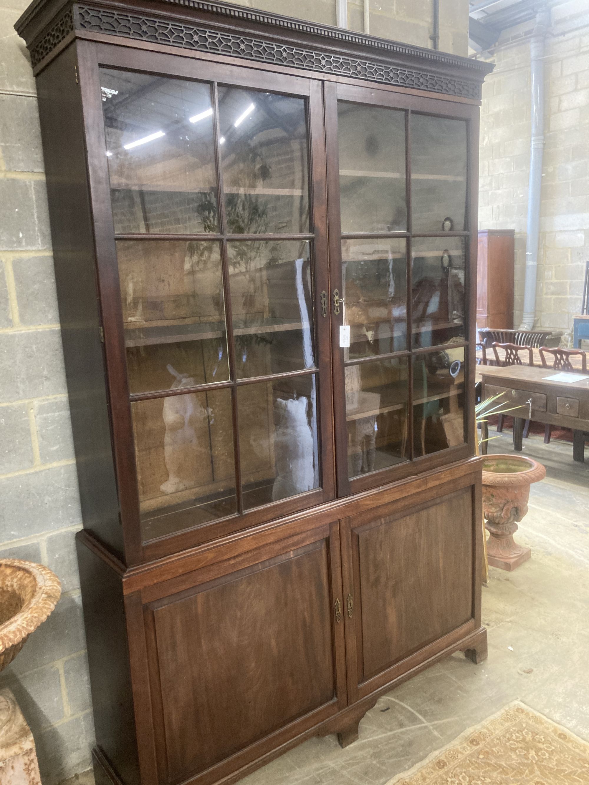 A George III mahogany bookcase cupboard, length 160cm, depth 40cm, height 245cm